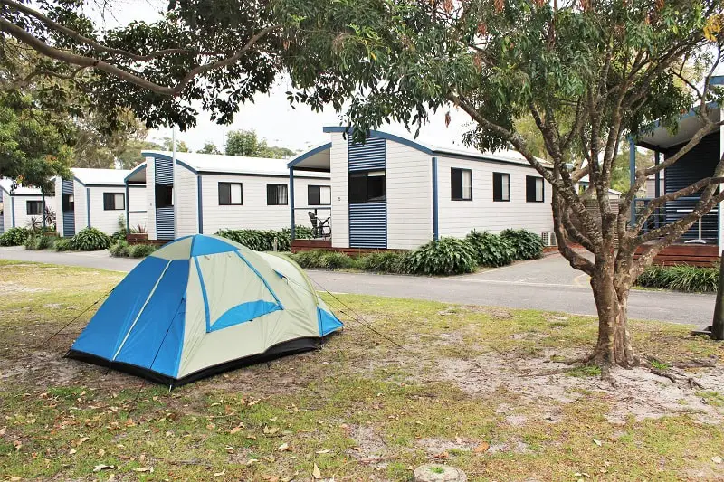 A holiday park in Australia with a tent and cabins.