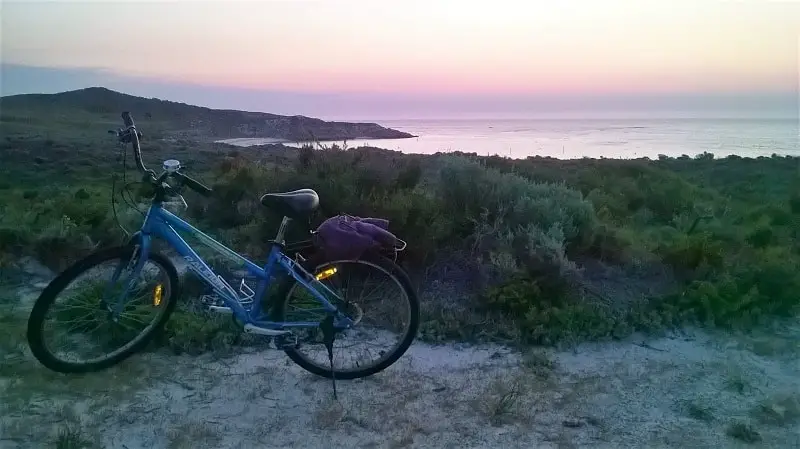 Pink sunset over the Indian Ocean and a bicycle in Western Australia.