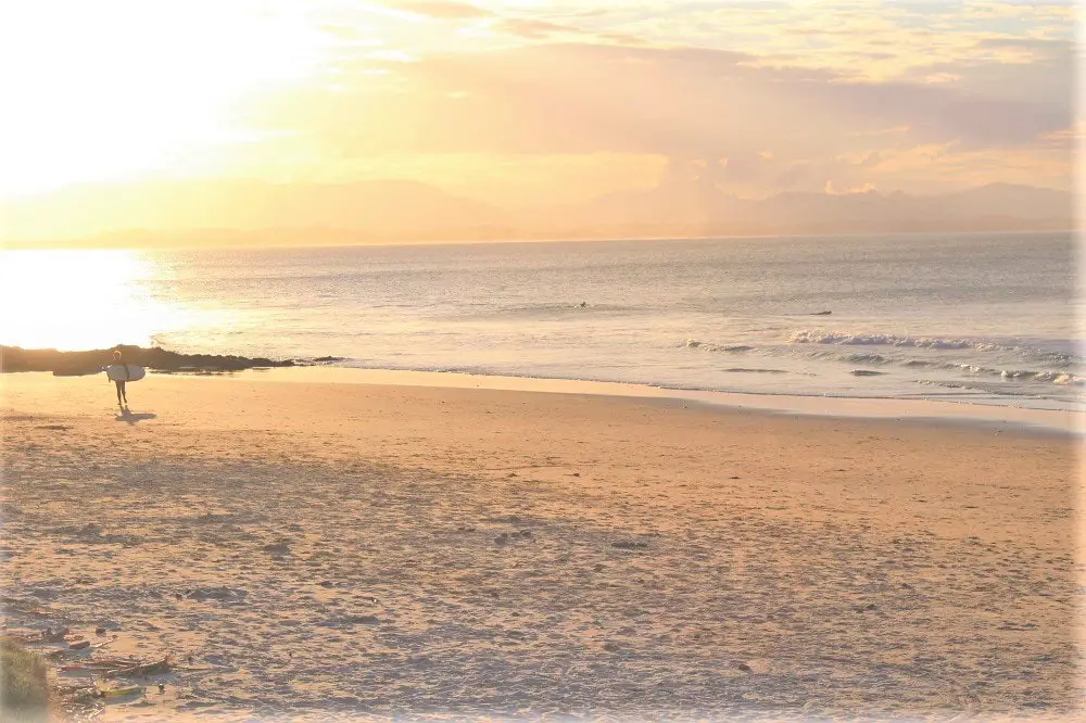 A gorgeous Byron Bay sunset at the beach in East Coast Australia. Byron Bay is a top holiday destination on a Sydney to Brisbane drive.