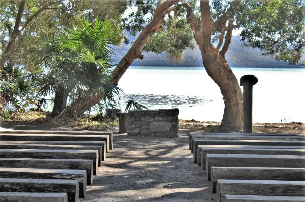Beautiful lake and pews at The Green Cathedral, Tiona, an outdoor church in Australia.