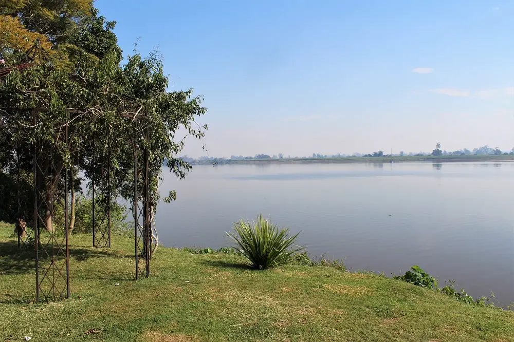 Hazy view across the river during sugar cane burning at the Ulmarra Hotel café gardens between Brisbane and Sydney.