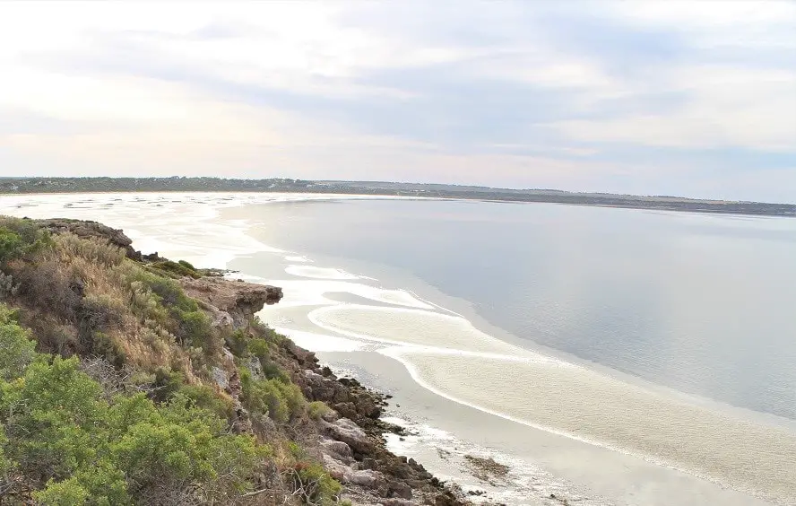 Beautiful pastel sunset over the water from a hill at Wittelbee Conservation Park, a camping area in South Australia.