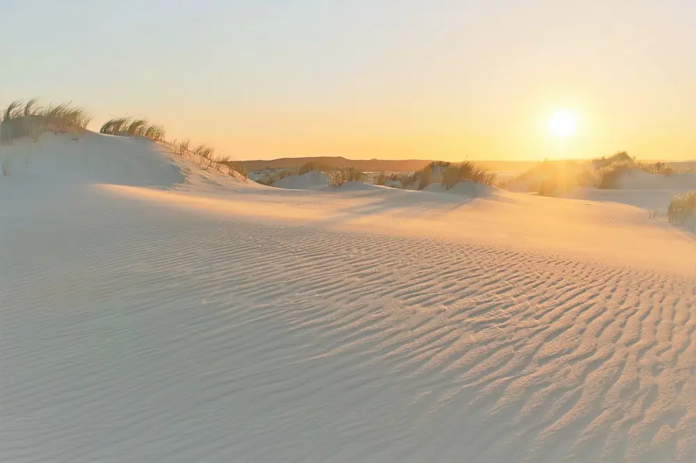 Absolutely stunning sunset at Yeagarup Dunes in Western Australia, with patterns in the sand lit up with an orange glow. This is a top recommended attraction on a Perth to Adelaide road trip.