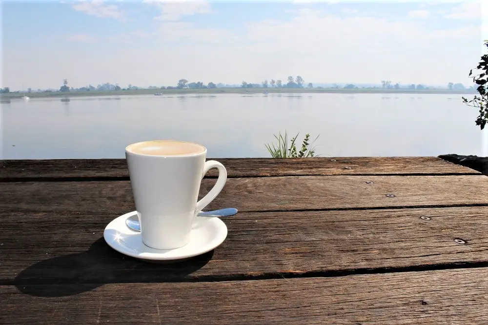 Cup of coffee by a lake at Ulmarra, Australia.