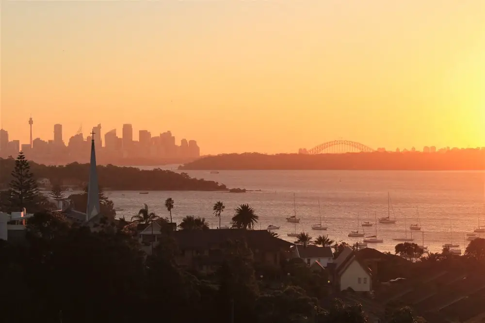 Amazing orange sunset and Sydney skyline and Harbour Bridge, viewed from Watsons Bay.