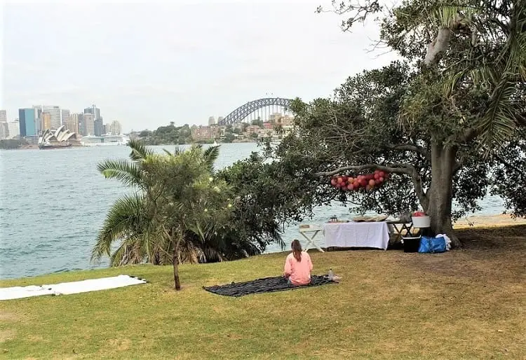 Woman having a picnic at Cremorne Point in Sydney.