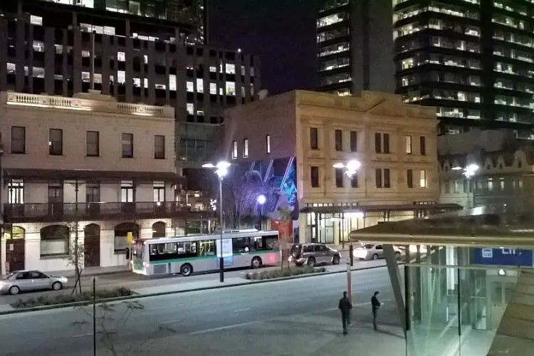 Bus and train station in Perth at night.