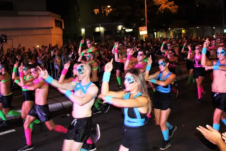Dancers in Sydney Mardi Gras Parade wearing fluorescent costumes.