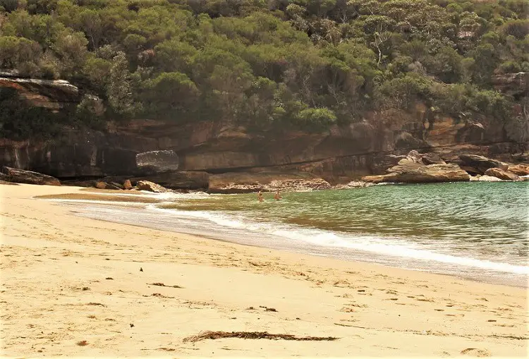Swimmers in the ocean at Wattamolla Beach in the Royal National Park.
