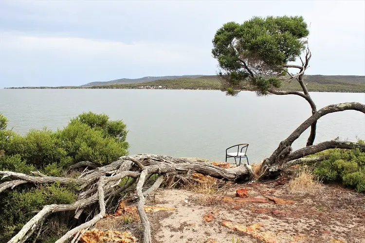Beautiful lake and a chair by the water at Millers Point Reserve camping ground, WA.