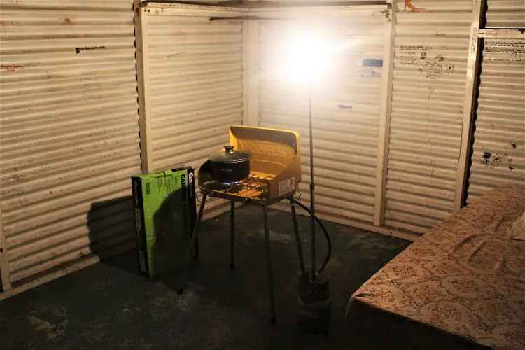 Camp stove and a mattress inside a dirty old fisherman's hut at Betty's Beach in Western Australia, where you can free camp.