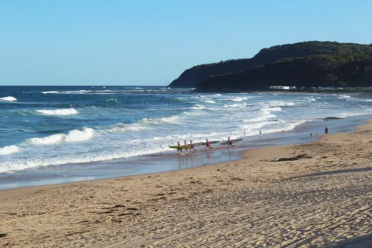 Surfers at Shelly Beach, Central Coast, NSW.