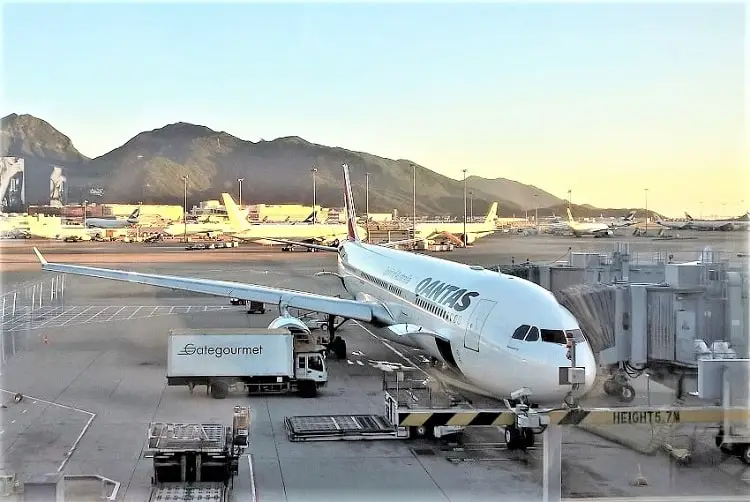 A Qantas aeroplane at Hong Kong Airport at sunset.