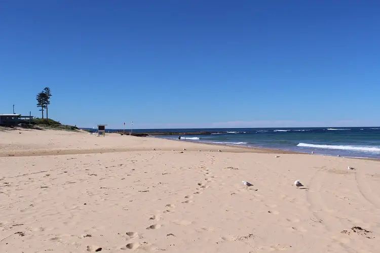 A beautiful sunny day at Bulli Beach, with Bulli Rock Pool in the distance.