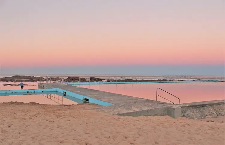 Pink evening sky reflected in Bulli Rock Pool at sunset.