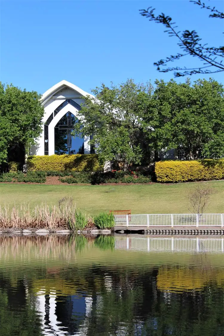 Hunter Valley Gardens chapel by a lake.
