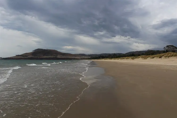 Moody, atmospheric photo of Seven Mile Beach in Hobart.