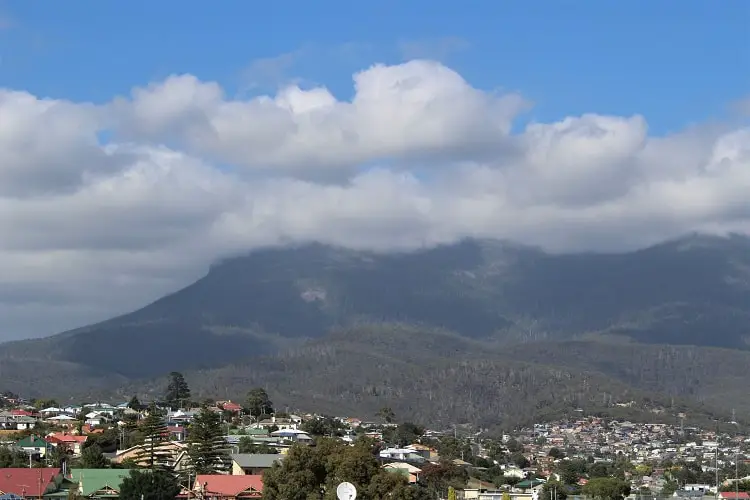 A bright, sunny day in Hobart with mountains and houses.