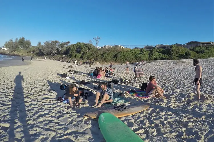 Backpackers enjoying Belongil Beach.