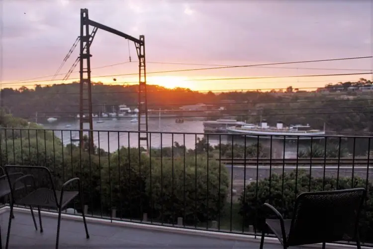 A beautiful sunset over the water taken on a balcony at a luxury paid house sit through MadPaws in MacMahons Point, Sydney, Australia.