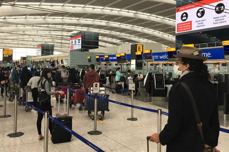 Long queues to check in for a London to Hong Kong flight during Covid-19.