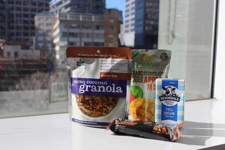 Breakfast in hotel quarantine Australia: granola, nut bar, orange juice and milk.