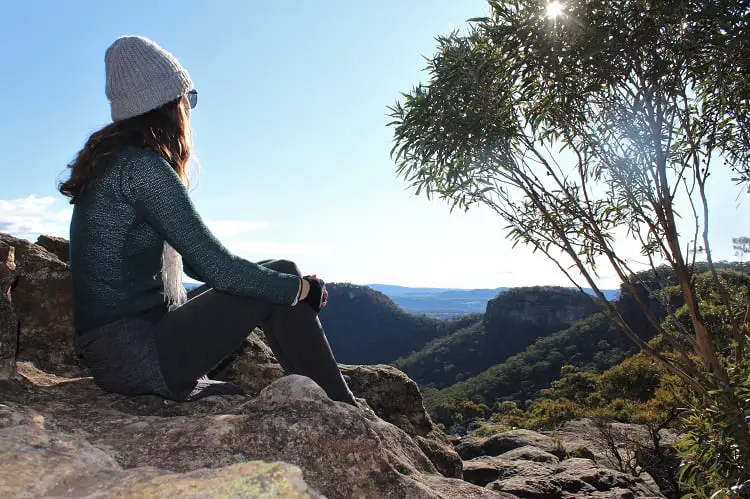 Female travel blogger admiring the view of the Blue Mountains from Sunset Rock in Mount Victoria.