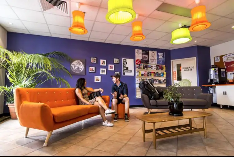 Reception area with colourful sofas at an Adelaide hostel.