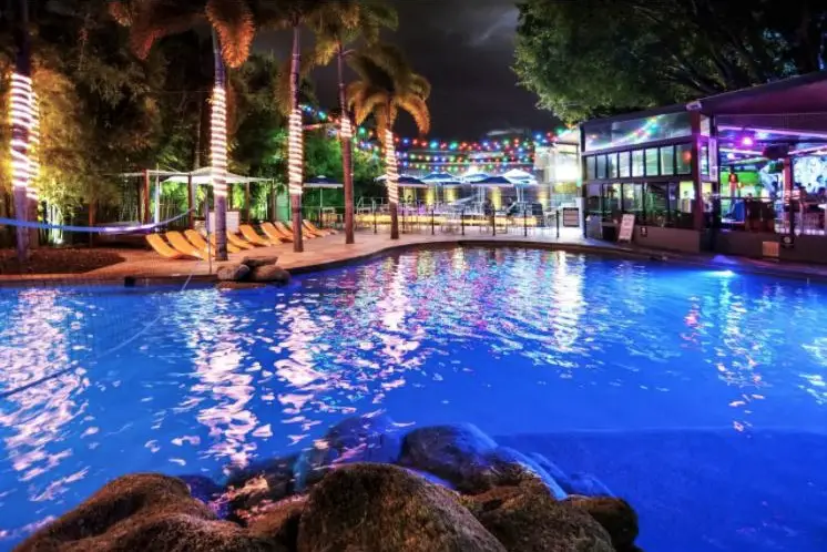 Swimming pool and outdoor bar at Gilligan's Backpacker Hotel and Resort in Cairns, Australia.