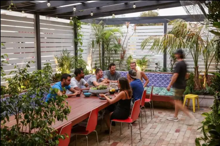 Backpackers in the garden courtyard at Spinners Hostel, Perth, Australia.