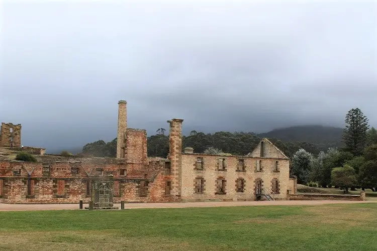 Atmospheric picture of Port Arthur ruins in Tasmania, under heavy grey cloud.