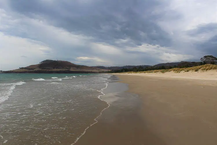 Seven Mile Beach in Hobart on a dark, cloudy day.