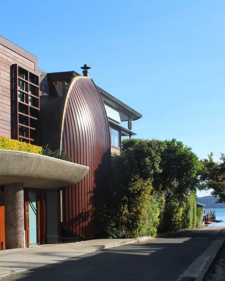A unique home by the beach in Palm Beach Sydney, with a curved wooden side that looks like a boat.