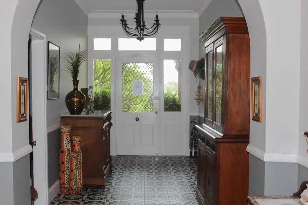 Beautiful entrance hall with antique furniture and tiled floor at Palmyra Bed and Breakfast accommodation in Forster NSW.