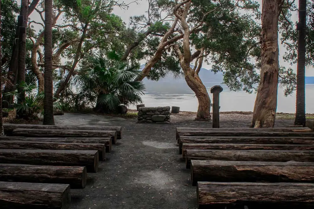 Log pews and Wallis Lake view at outdoor Green Cathedral in Tiona.