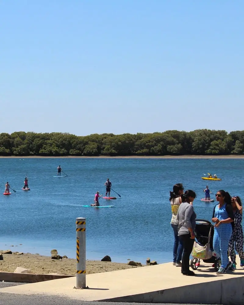 People doing SUP at Port Adelaide, a typical part of Adelaide's outdoor lifestyle.