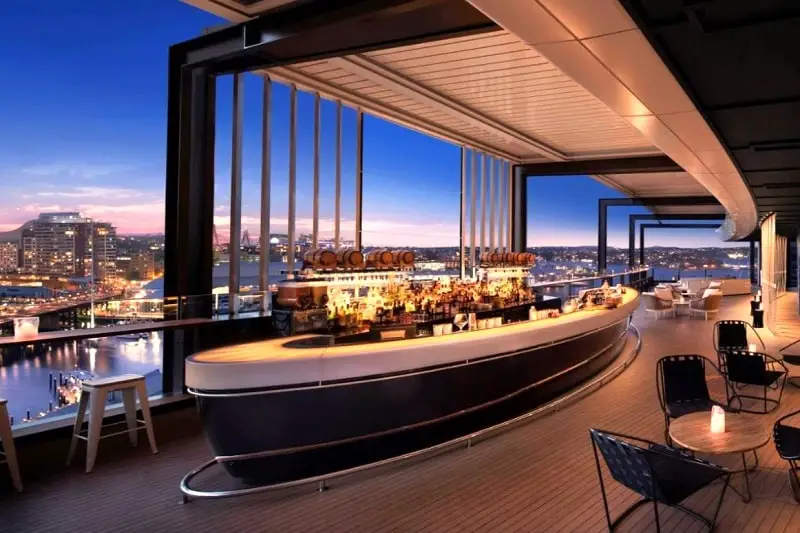 Beautifull lit bar and sunset view in 5-star Hyatt Regency Hotel in Sydney.