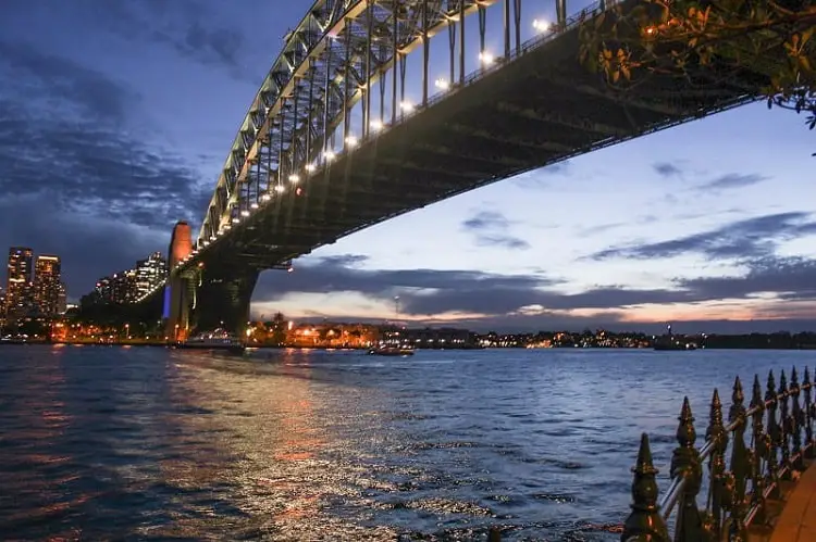 Sydney Harbour Bridge lit up just after sunset.
