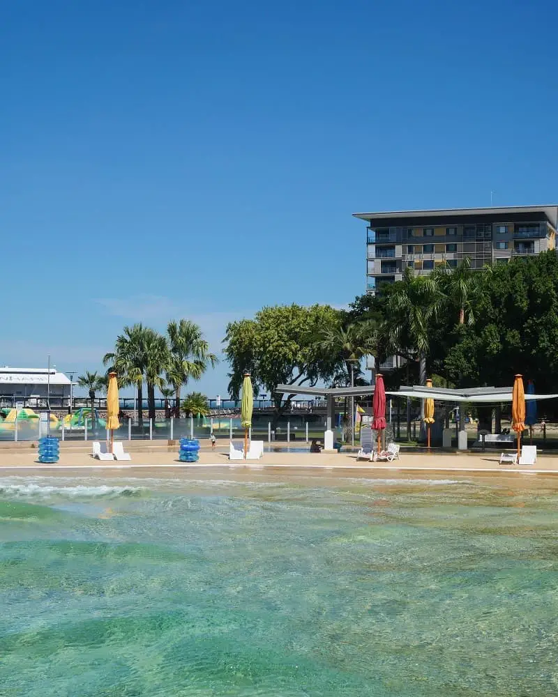 Darwin wave lagoon and sun loungers with coloured parasols.